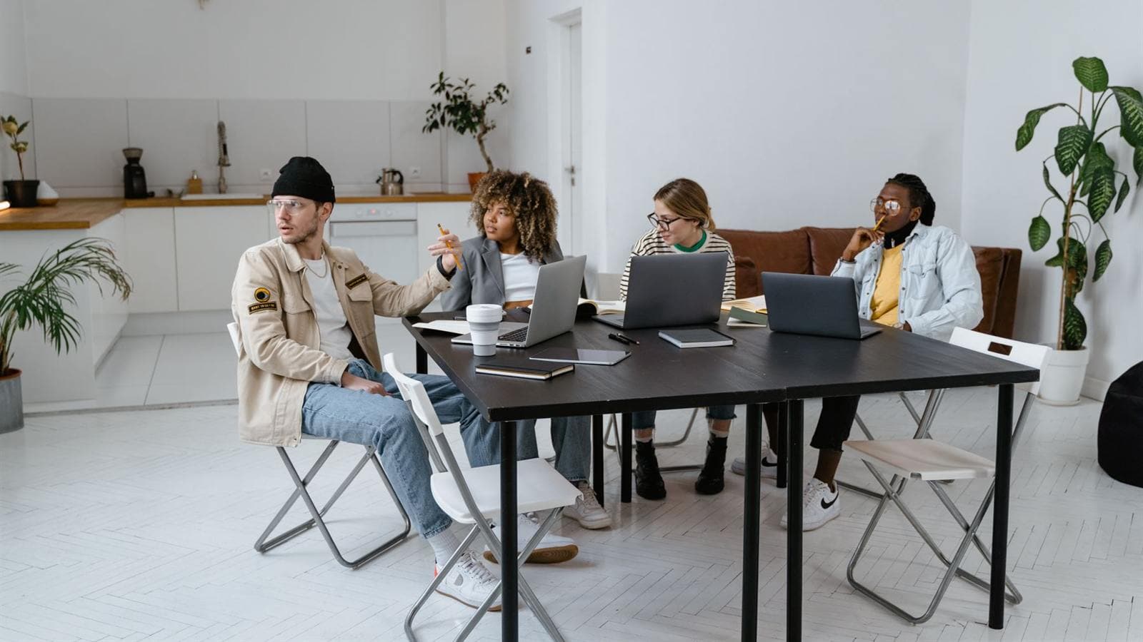 A group working together around a long table in a bright, open room.